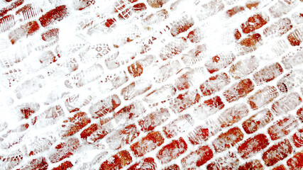 pavement of red bricks in the snow