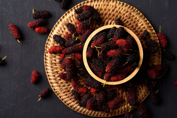 Mulberry fruit from local market on black background, Tropical fruit in spring and summer season