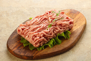 Raw minced pork meat over board