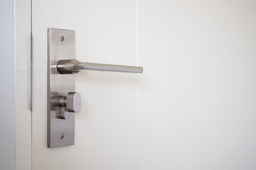 Naklejka premium Modern door handle with on white door