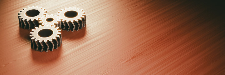gear mechanism on a wooden surface (four worn metallic double helical gears) - obrazy, fototapety, plakaty