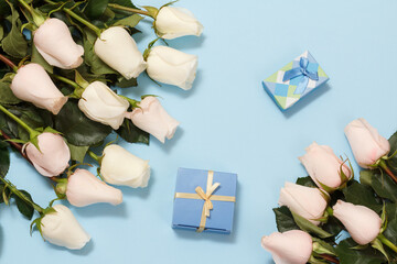 Gift boxes with rose flowers on the blue background.