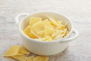 Sliced parmesan cheese heap in the bowl
