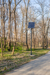Sunny day on the promenade in the city park . Solar panels of the alternative energy system have been installed on the promenade in the city park in Kamenica, near the city of Novi Sad.