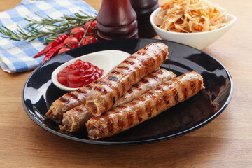 Grilled sausages with cabbage and sauce
