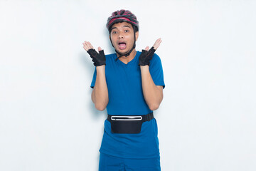 young asian man cyclist shocked isolated on white background
