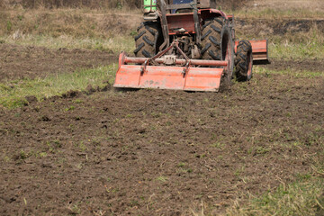 Obraz premium Tractor working in farmland. Agriculture industry for living in the country. 