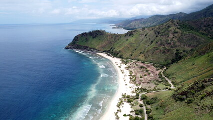 Fototapeta na wymiar The stunning white sandy beach known as back beach near Cristo Rei, aerial drone view of landscape, in Dili, Timor Leste, Southeast Asia