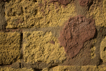evocative image of the surface of old porous tuff bricks 
