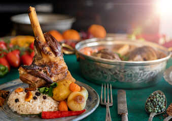 A plate of grilled lamb with iç pilav, small plates, carrots. Tandır kebabı 