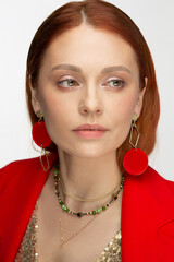 Portrait of a beautiful business woman. Thirty or forty years. In the ears are red earrings, jewelry.