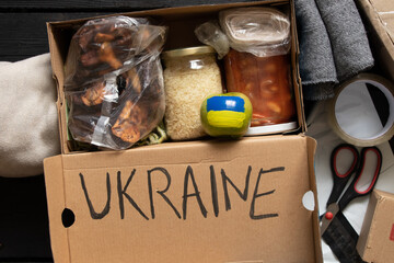 Collecting a humanitarian food set to help people who suffered during the war at the hands of...