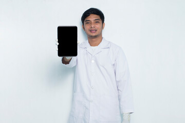 portrait of asian medical doctor demonstrating mobile cell phone isolated on white background
