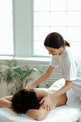 Young woman making massage at spa center