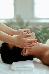 Obraz na płótnie Canvas Young woman making massage at spa center