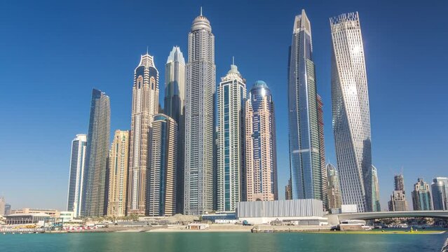 Scenic view of Dubai Marina Skyscrapers with boats timelapse, Skyline, View from sea, United Arab Emirates