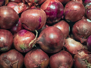 Closeup of fresh raw red Onions at a farmer's market