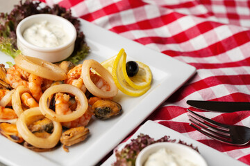 Cooked seafood on plate on gray background
