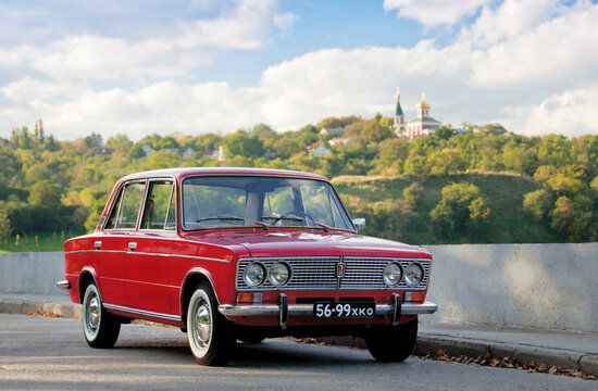 KYIV, UKRAINE-JULY 4, 2016: Old Soviet car VAZ-2103 "Zhiguli" at Old Car Fest show, JULY 4, 2016 in Kyiv, Ukraine.Red retro car parked on the road against the background of green hills in a sunny day.