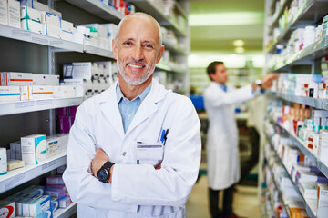 Here for your health. Portrait of a confident mature pharmacist working in a pharmacy.