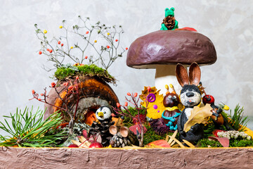 Animals and a mushroom are made of plasticine. Children's hobby. Composition of soft colored...