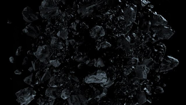 Super slow motion shot of rotating exploded scattered coal on black at 1000fps.