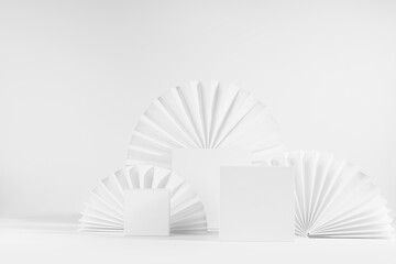 Set of three different size square white podiums mockup with oriental paper fan in minimal style, stage for presentation of cosmetic product or goods, advertising, design, copy space, front view.