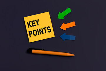 KEY POINTS - concept of text on sticky note. Business concept. Orange square sticky note, pen and colorful arrows on dark blue background, top view