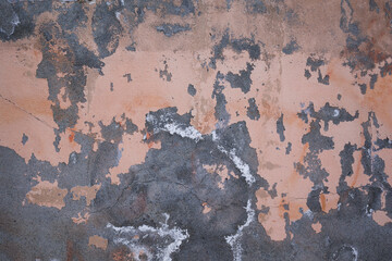 Texture of concrete wall covered with old broken stucco