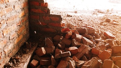 Close-up of the rubble of an industrial building collapsing into a pile of concrete and brick. and...