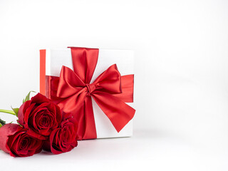  Box with red bow and red roses on white background for decoration. Promotional template. Holiday concept. Creative modern design.