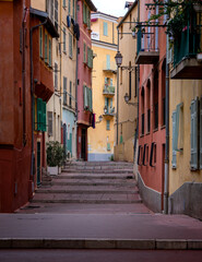Fototapeta na wymiar Cozy narrow street with beautiful and colorful buildings in Nice, France