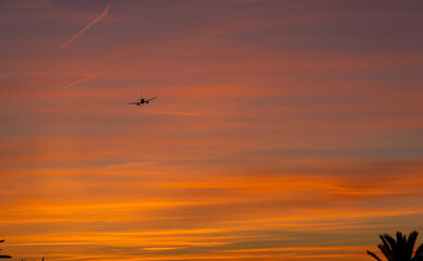 Silhouette of a passenger aircraft, taking off at the golden hour sunset.
