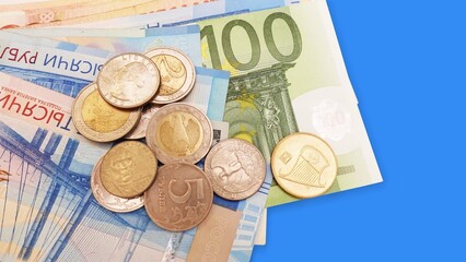 Top view of a multi-currency in very Peri tone. Euro, dollar, ruble banknotes isolated on blue background.Cash. The concept of financial literacy and savers. stack of dollar surrounded by euros and