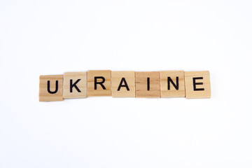 Top view of word ukraine is laid out of wooden squares isolated on white background. Concept of peace, war in Ukraine,support,no war