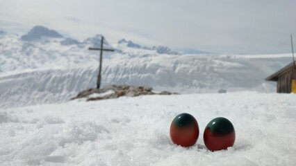summit cross on mount Krippenstein in the snow with easter eggs