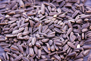 Small sunflower seeds are scattered on the table.