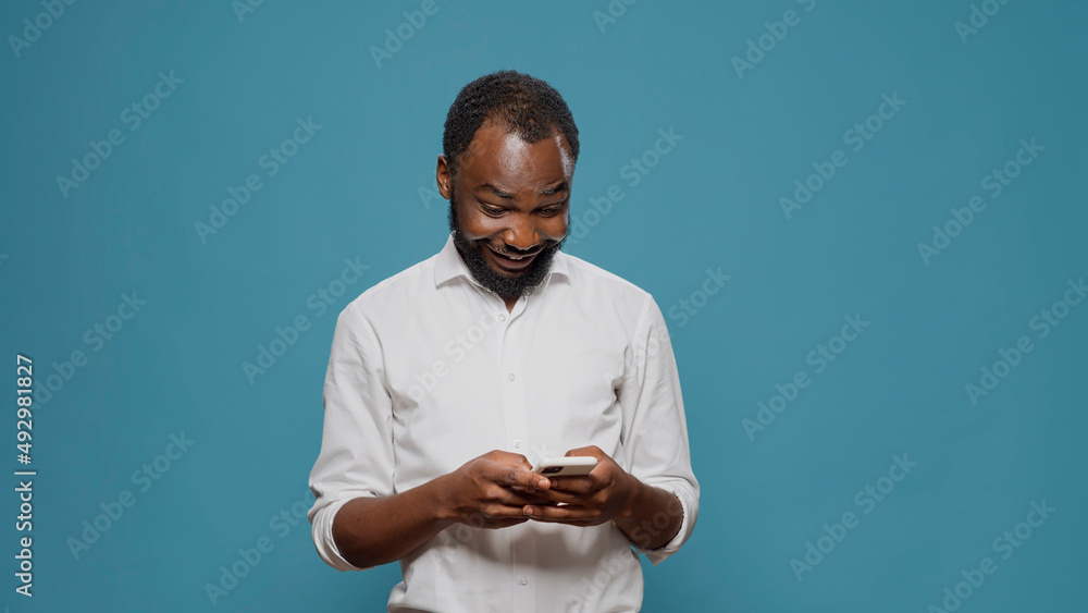 Poster millennial worker using social media app to text messages on smartphone, talking on online sms chat.