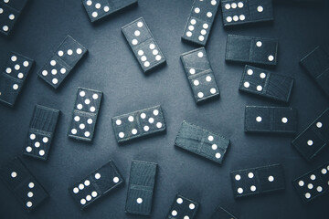 Black dominoes on dark table background