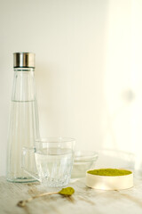 Green herbal detox powder in a plate on wooden table. Superfood. Organic eco health care. Vitamin nutrition and treatment. Immune system support. Alternative medicine. Dietary supplement, bowel clean.