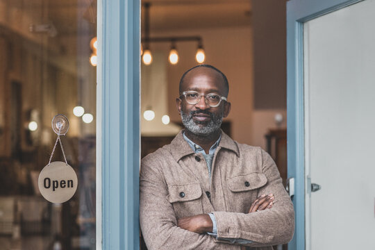 Portrait of store owner opening for business