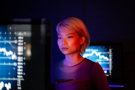 Asian female working on a computer bitcoin mining in a futuristic style