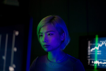 Asian female financial trader in futuristic style