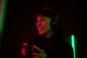 Female Gen Z gamer using a video game console