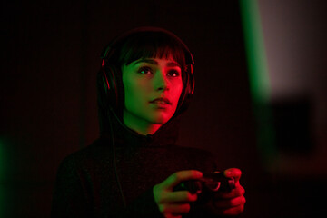 Female Gen Z gamer using a video game console