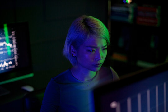 Asian female computer hacker in a futuristic style