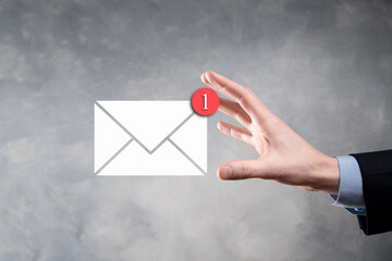 Businessman hand holding e-mail icon, Contact us by newsletter email and protect your personal...