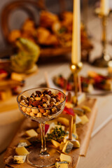 Assortment of nuts in bowls. Cashews, hazelnuts, walnuts, pistachios, pecans, pine nuts, peanuts, macadamia, almonds, brazil nuts. Food mix on wooden background, top view, copy space