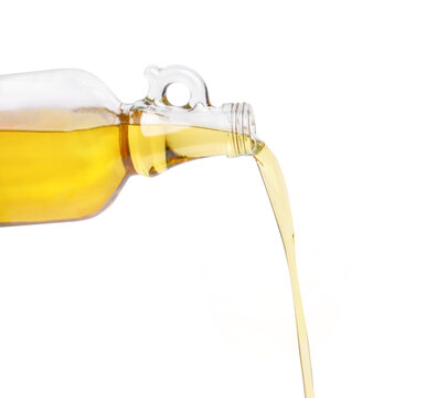 pouring oil from glass bottle isolated on white background