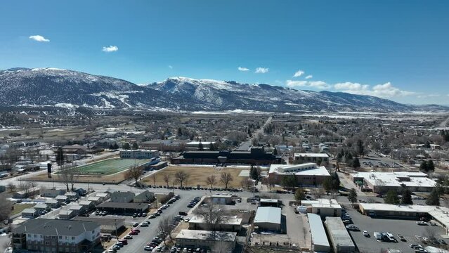 Aerial rural Ephraim Utah Snow College campus part 1 4K. Rural college university in Ephraim central Utah. Education, learning, sports and technical study. Early spring weather and climate. Campus.